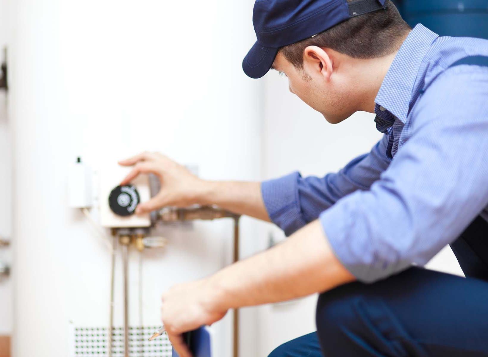 man adjusting water heater