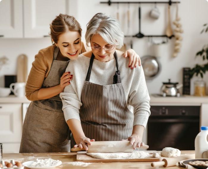 Woman with her older mother baking